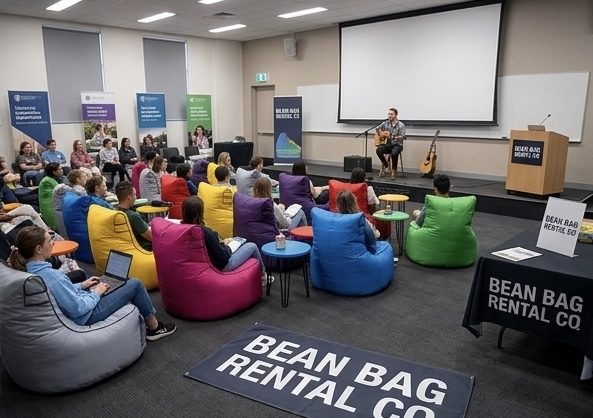Bean Bag Rental Co bean bags set up at an indoor event with live music and guests seated casually