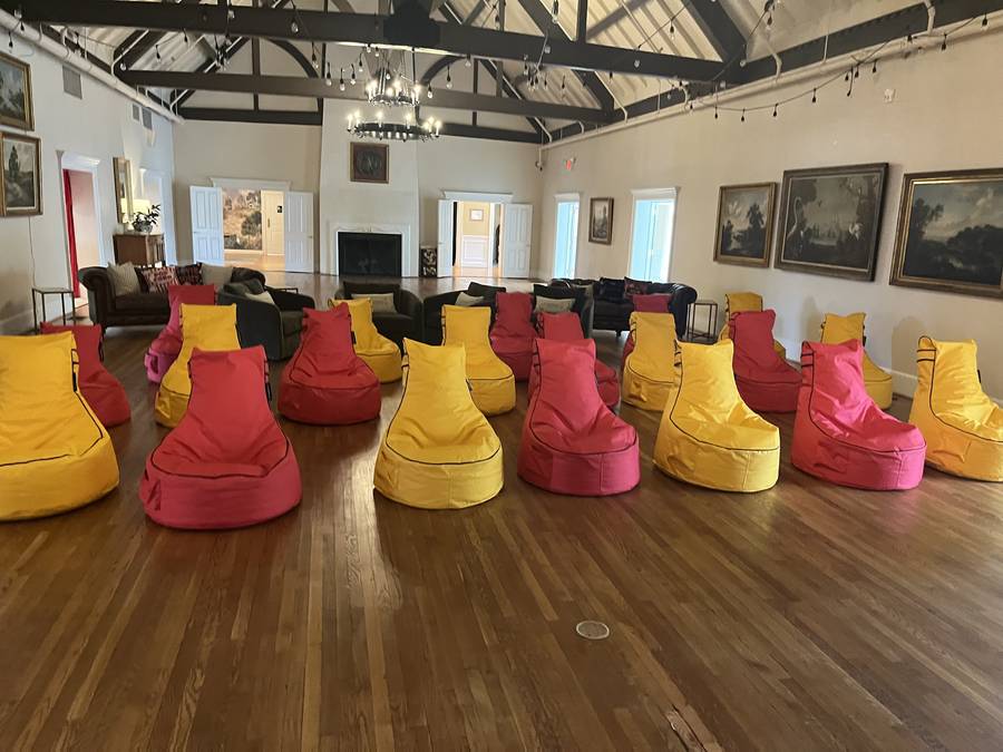 High-back bean bag chairs in yellow, red and pink on a ballroom floor